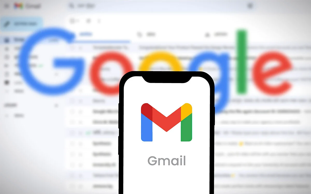 Gmail Logo on Phone in Front of Gmail Webpage